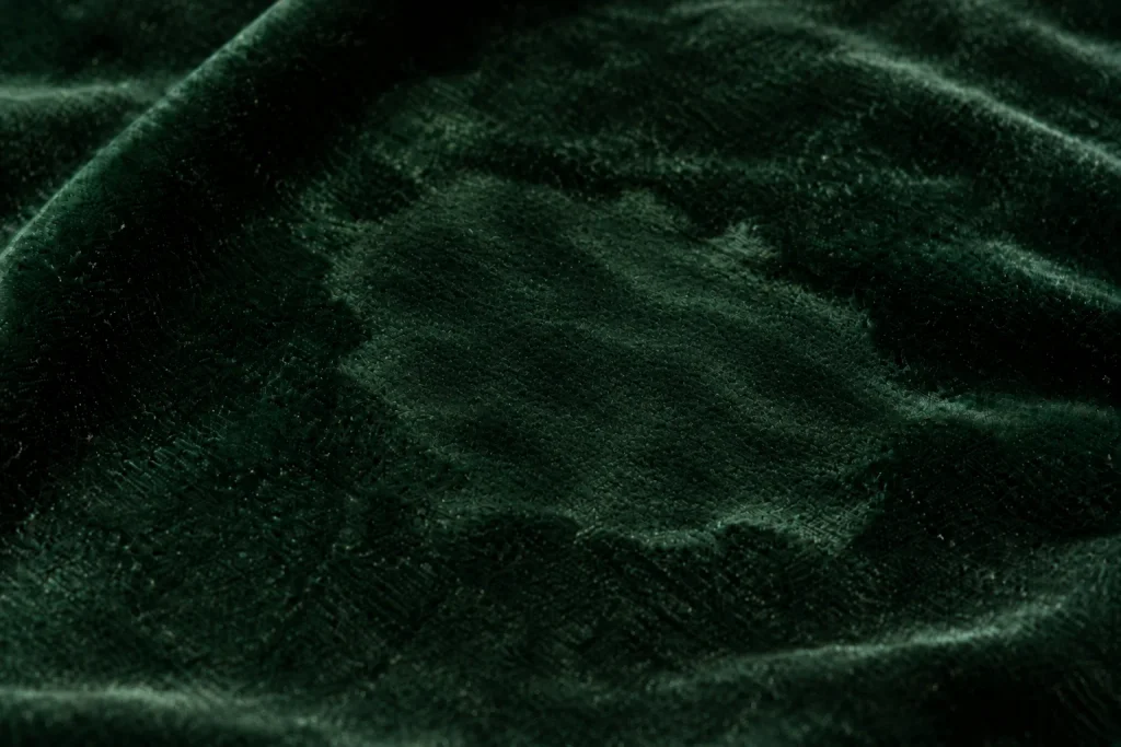 Crushed velvet pile catching the light differently from the surrounding fabric.