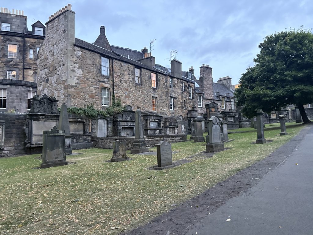 Gravestones and old stone buildings in Greyfriars Kirkyard, Edinburgh.