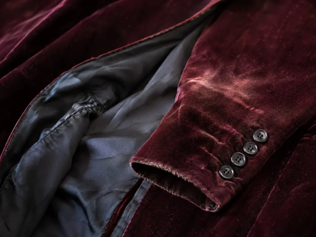 Flattened velvet pile and worn lining on a burgundy jacket