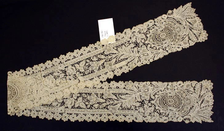 French cotton jabot from about 1882 with layered white ruffles falling from the neck.