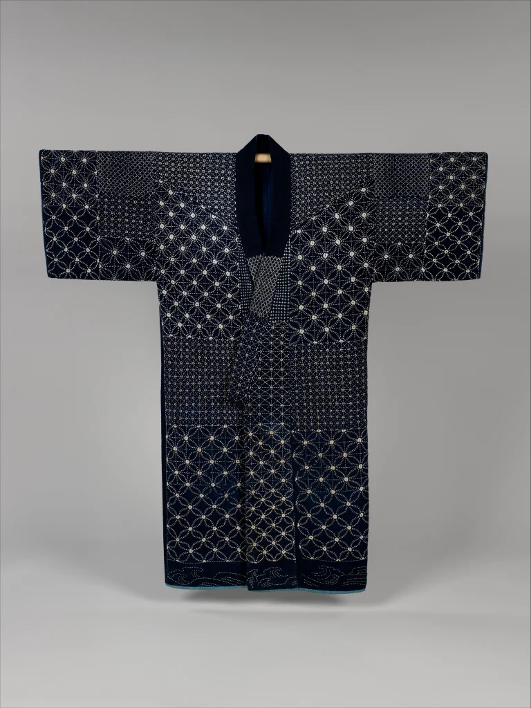 Nineteenth-century Japanese indigo cotton sashiko jacket embroidered with white running-stitch patterns.